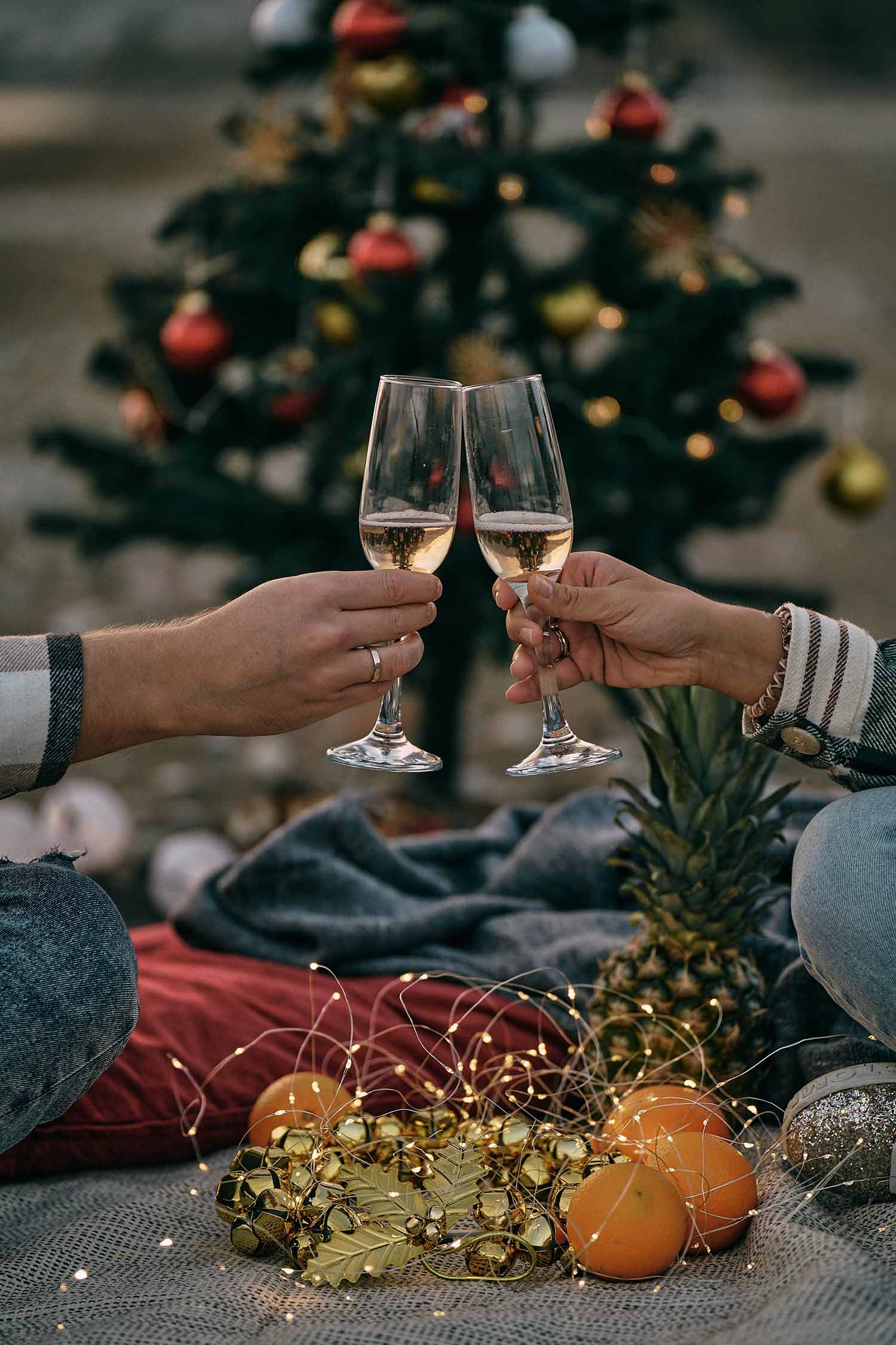 a couple of people clinking glasses with champagne